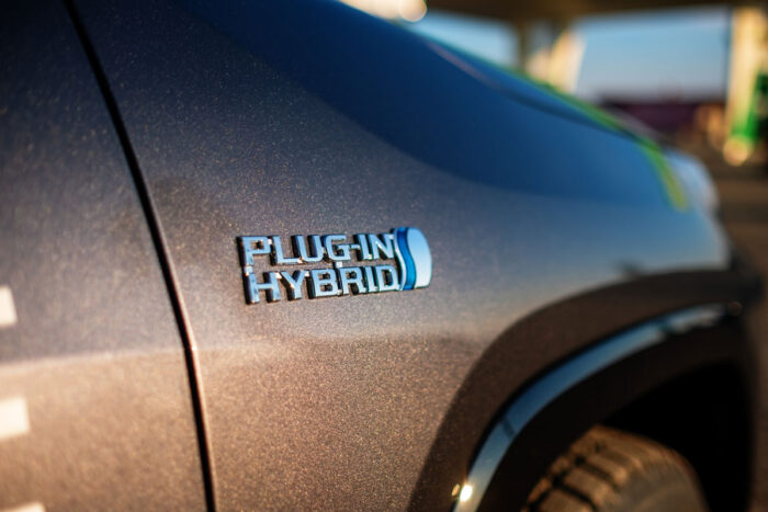 Close up of embossed text that says 'plug in hybrid' on a Toyota RAV4 Hybrid vehicle.