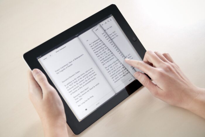 Woman reading William Shakespeare poetry on Apple iPad, apple e-books