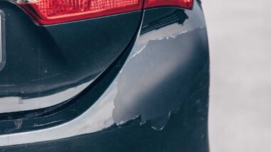 Close up of paint on a bumper cracking and peeling, representing the Honda paint defect settlement.