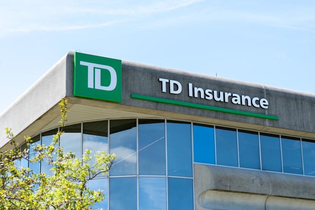 Close up of TD Insurance signage against a blue sky.