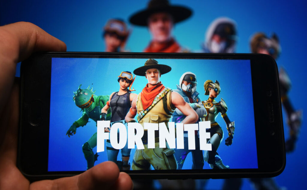 Close up of Fortnite logo displayed on a smartphone screen.