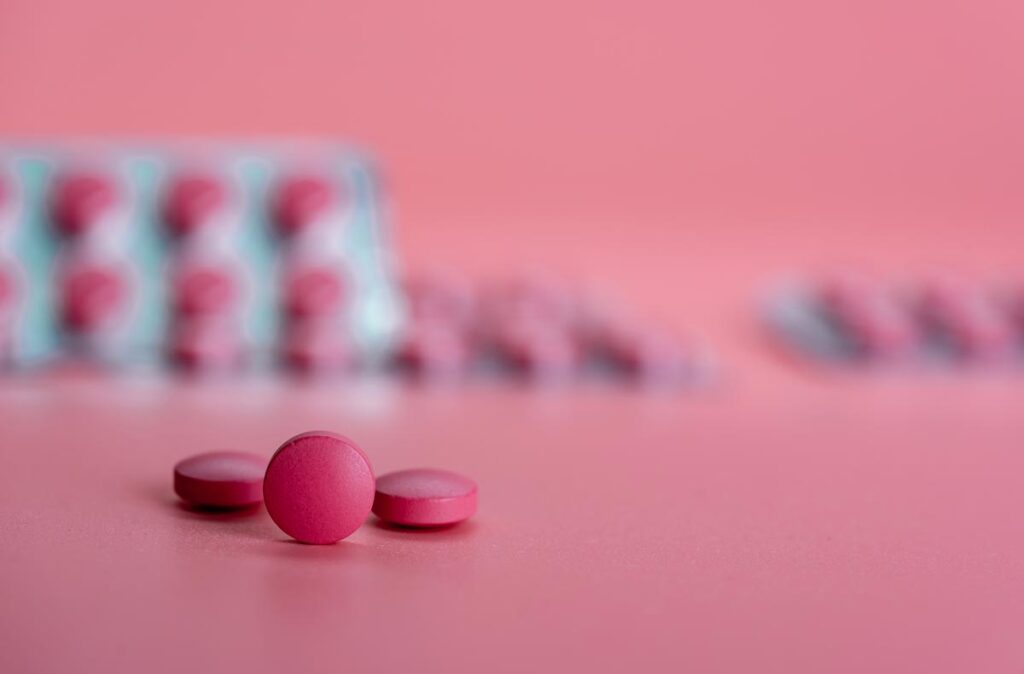 Close up of pink pills, representing the Alysena class action settlement.