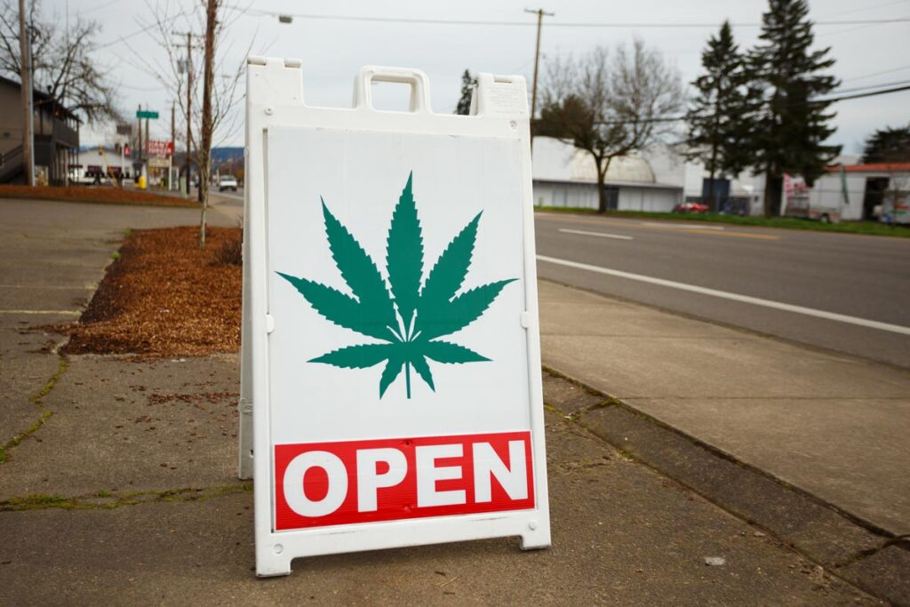 Close up of an open sign outside of a dispensary.