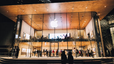 Exterior of an Apple Store at night, representing the AppleCare warranty settlement.