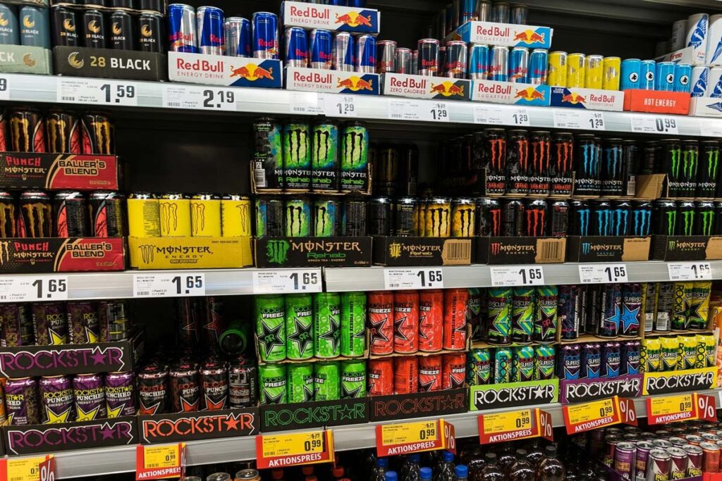 Various energy drink products on a grocery store shelf, representing the caffeinated energy drink recall.