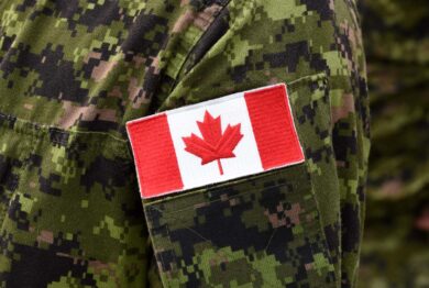 Close up of the Canadian flag on a military uniform, representing the Veterans Affairs Canada disability pension miscalculation settlement.