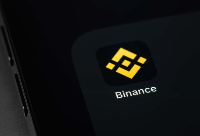 Close up of Binance app icon displayed on a smartphone screen, representing the Binance fine.